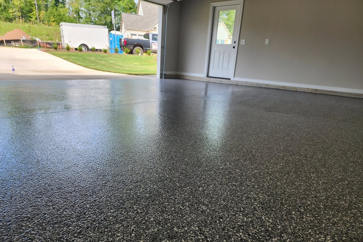 Flake epoxy garage floor with the door open to a new subdivision street